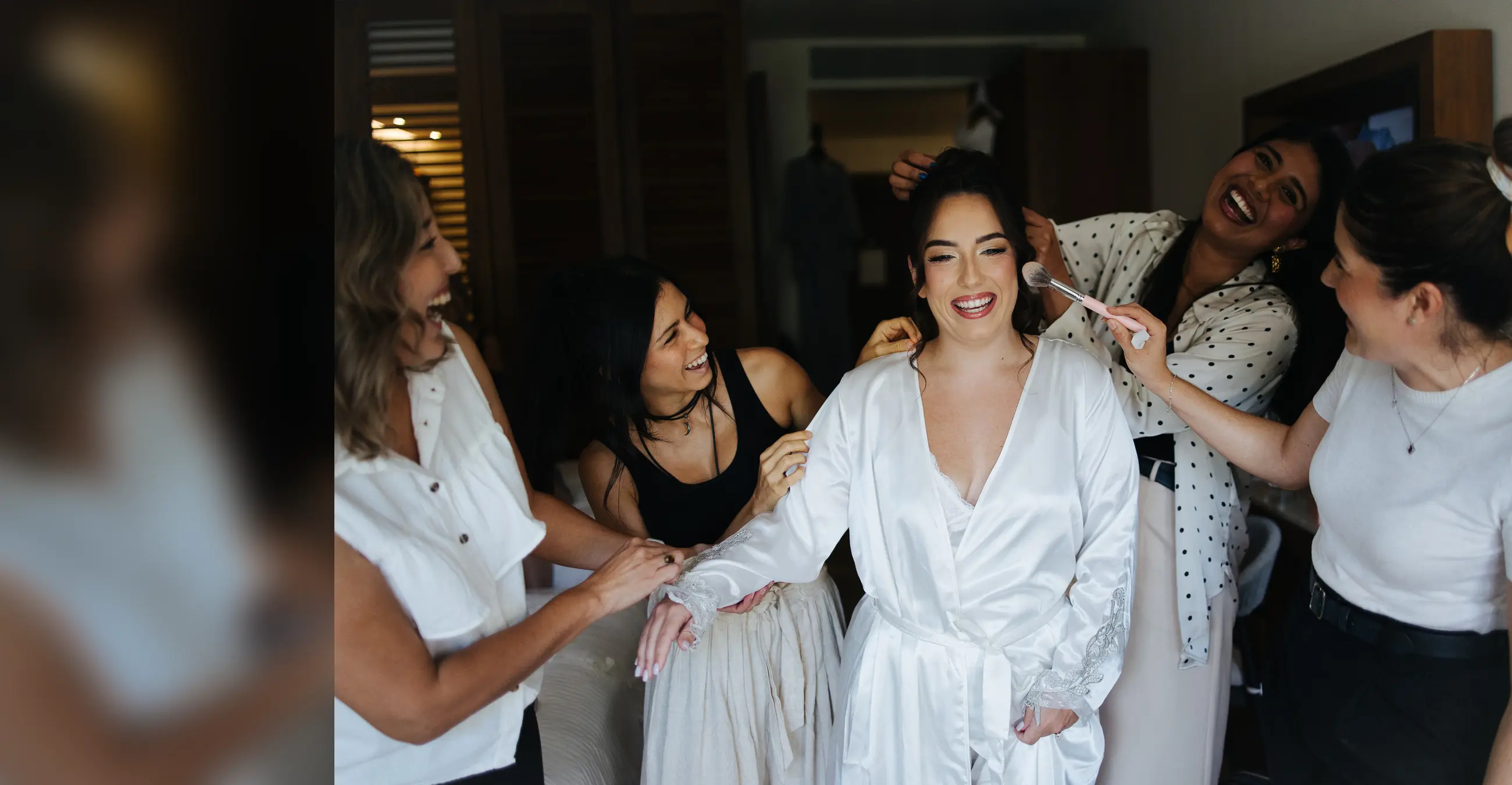 Full scene of the Sara Tamargo beauty team preparing a joyful destination bride