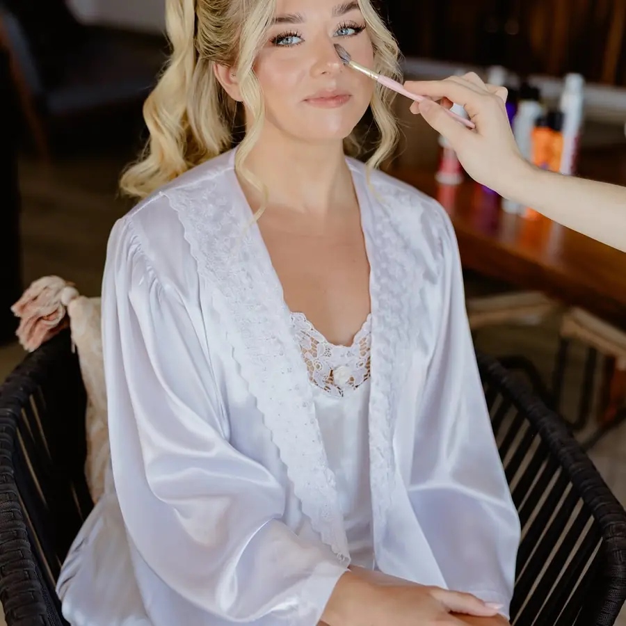 Luminous bridal makeup and softly styled blonde hair